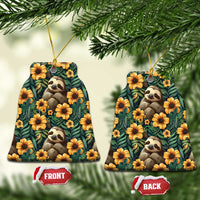 Round ceramic ornament pair featuring sloths with orange flower accents on dark green pattern