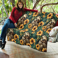 Green sloth quilt with yellow-orange blooms, draped over outdoor seating