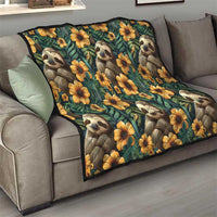 Green sloth quilt with yellow flowers, laid across a gray sofa