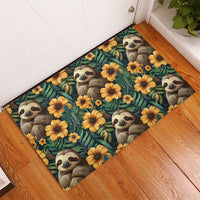 Rubber doormat featuring sloth faces and yellow-orange flowers on dark teal background