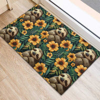Corner view rubber doormat, repeating sloth faces amid yellow-orange flowers on dark teal