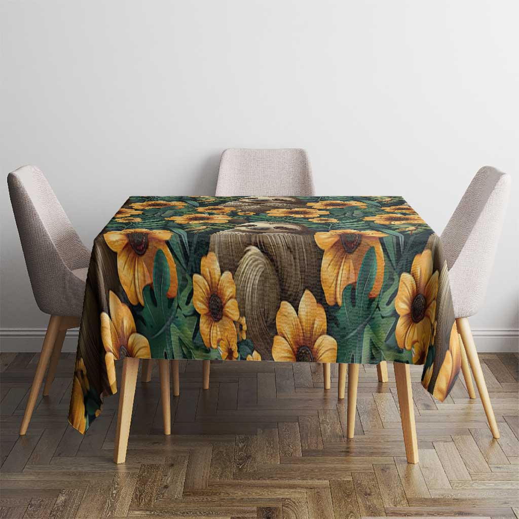 Green seamless tablecloth with sloths and yellow flowers, covering dining table.