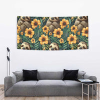 Green tapestry with sloth faces and orange/yellow flowers, rectangular wall hanging
