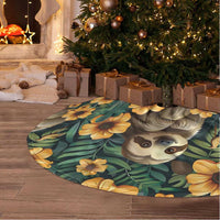 Green oval tree skirt with sloth portrait print and yellow flowers on tropical leaves.