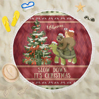 Round red Christmas beach blanket featuring sloth, turtle, and pine tree design, white fringe