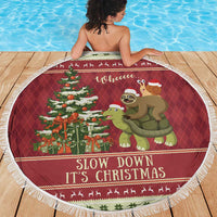 Round red Christmas beach blanket with sloth riding turtle and tree graphic, white fringe