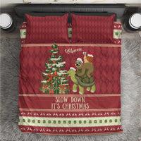 Red Christmas bedding set on bed with sloth and turtle scene, tree graphic, 2 pillows