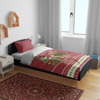 Red Christmas bedding set on wooden bed with sloth riding turtle quilt and 2 pillows