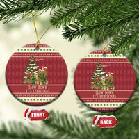 Red circular ceramic Christmas ornament with sloth and snail on turtle; gold string