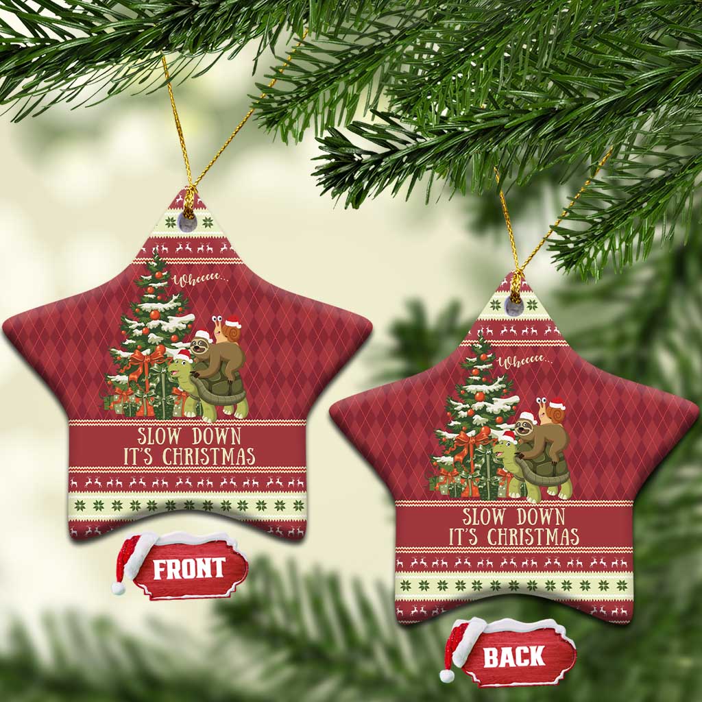 Red star-shaped ceramic Christmas ornament with sloth and snail on turtle; gold string