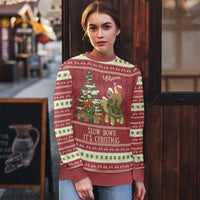 Red ugly Christmas sweater on model, sloth and turtle by Christmas tree with “Slow Down It’s Christmas”