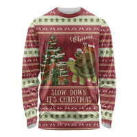 Red crewneck long-sleeve Christmas shirt with sloth riding turtle graphic