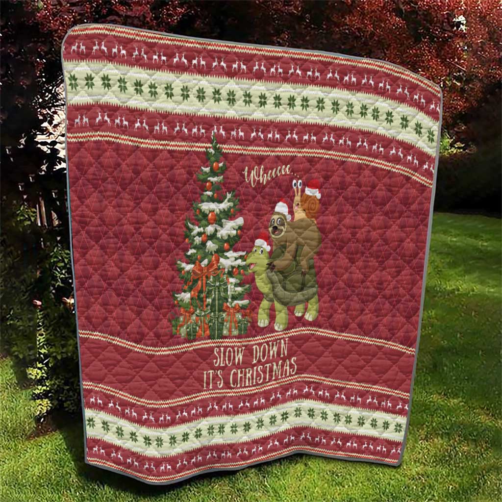 Red Christmas quilt on grass with sloth riding turtle, tree scene, and repeating festive border.
