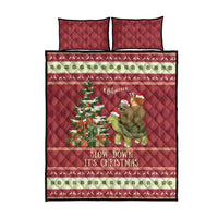 Red quilt bed set with sloth riding turtle, “Slow down it's Christmas” and two pillows