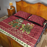 Red quilt bed set with sloth riding turtle artwork and “Slow down it's Christmas” stripe