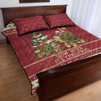 Red quilt bed set with sloth riding turtle graphic, “Slow down it's Christmas” text band