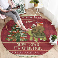 Red round Christmas rug with sloth and snail riding a turtle, 'Slow down It's Christmas'