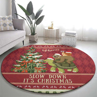 Red round Christmas rug with sloth on turtle, 'Slow down It's Christmas'