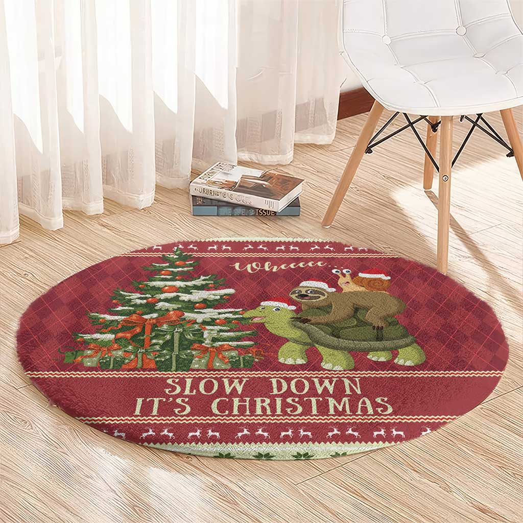Red round Christmas rug with sloth and turtle illustration and 'Slow down It's Christmas'