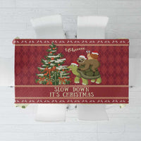 Red Christmas tablecloth with sloth and turtle graphic and 'Slow down It's Christmas'