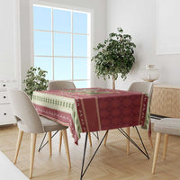 Red Christmas tablecloth with sloth and turtle scene and green-and-white border