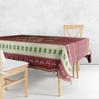 Red Christmas tablecloth with green clover pattern and holiday animal silhouettes
