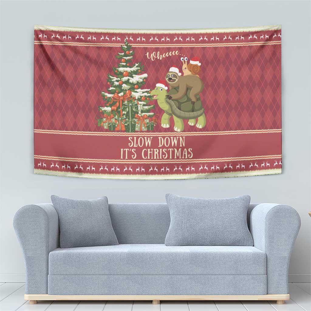 Red Christmas tapestry showing a sloth and turtle holding a snail beside a decorated tree