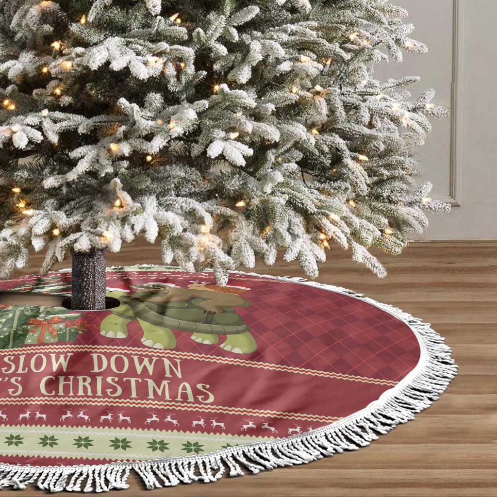 Red Christmas tree skirt with white fringe edge and cartoon animals near tree base