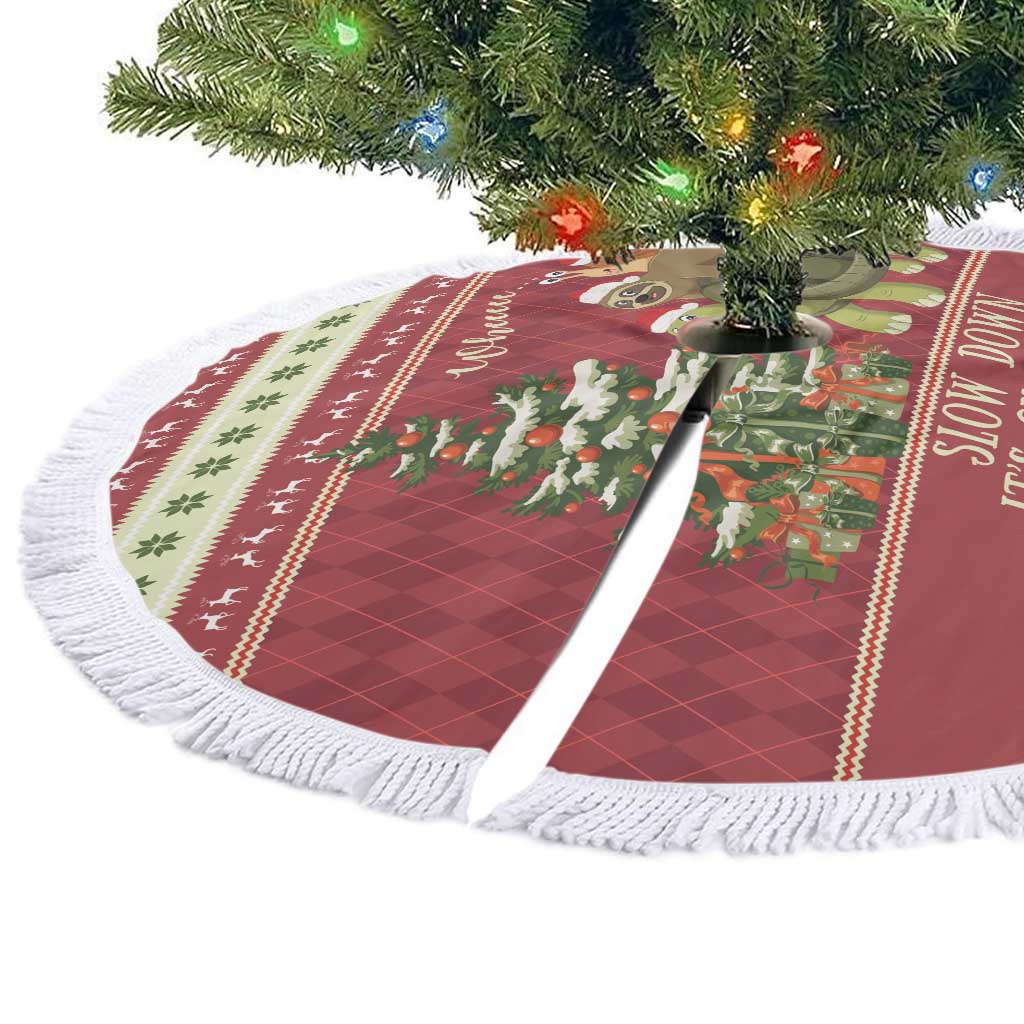 Red round Christmas tree skirt with white tassel fringe and festive animal graphic