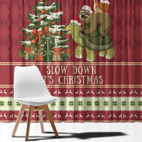 Red Christmas curtain close-up with sloth and turtle characters and "Slow Down It's Christmas" text