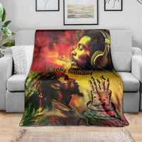 Happy birthday reggae king blanket draped over gray sofa, portrait and birthday cake graphic