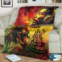 Happy birthday throw blanket over cream couch, red yellow black king portrait and cake