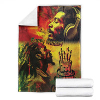 Happy birthday throw blanket with reggae king portrait, stacked with folded white towels