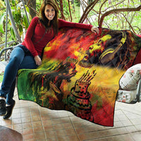 Reggae quilt draped on a person, with king portrait, “Happy Birthday,” and diamond quilted texture