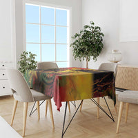 Reggae birthday tablecloth in red, yellow, green abstract print, draped on dining table