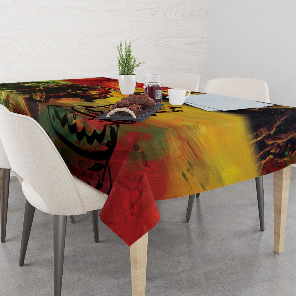 Reggae birthday tablecloth with swirling red and yellow design, hanging corner on table