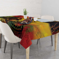 Reggae birthday tablecloth with swirling red and yellow design, hanging corner on table