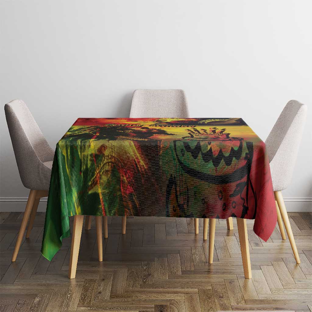 Reggae birthday tablecloth, vibrant green and red print with yellow swirls, on dining table