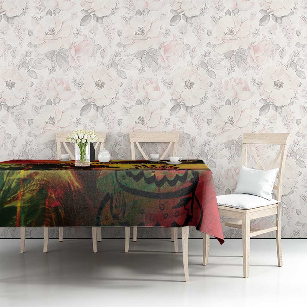 Reggae birthday tablecloth on rectangular table, multicolor abstract print with cake details