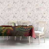 Reggae birthday tablecloth on rectangular table, multicolor abstract print with cake details