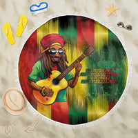 Round beach blanket with reggae-style guitarist graphic and white fringe border