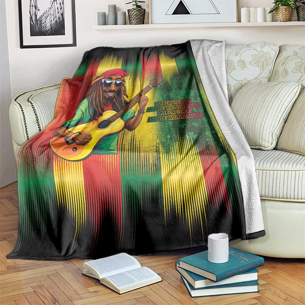 Bob birthday blanket with guitarist graphic and green red yellow streaks, draped on couch