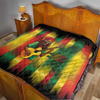 Multicolor Bob portrait quilt on bed with black backing and bold rasta stripe design