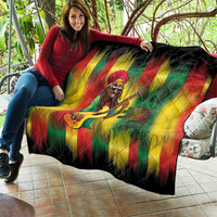 Reggae portrait quilt draped over couch, black border with rasta green yellow red stripes