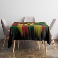 Rectangular reggae striped tablecloth in red, green, and yellow on a black base