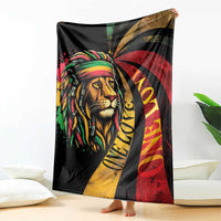Black blanket featuring a lion head graphic in reggae colors with red, yellow, and green rays