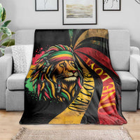 Black lion portrait blanket with green, red, and yellow accents and flowing dreadlocks graphic