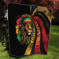 Quilted black blanket with lion portrait, rainbow headwrap, and red-yellow swirl pattern.