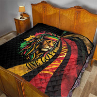 Black quilt on bed with colorful lion portrait and visible “ONE LOVE” text.