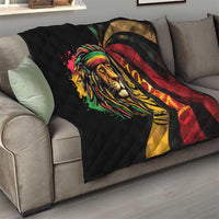 Black quilted blanket on sofa featuring colorful lion face and red-yellow swirl background.